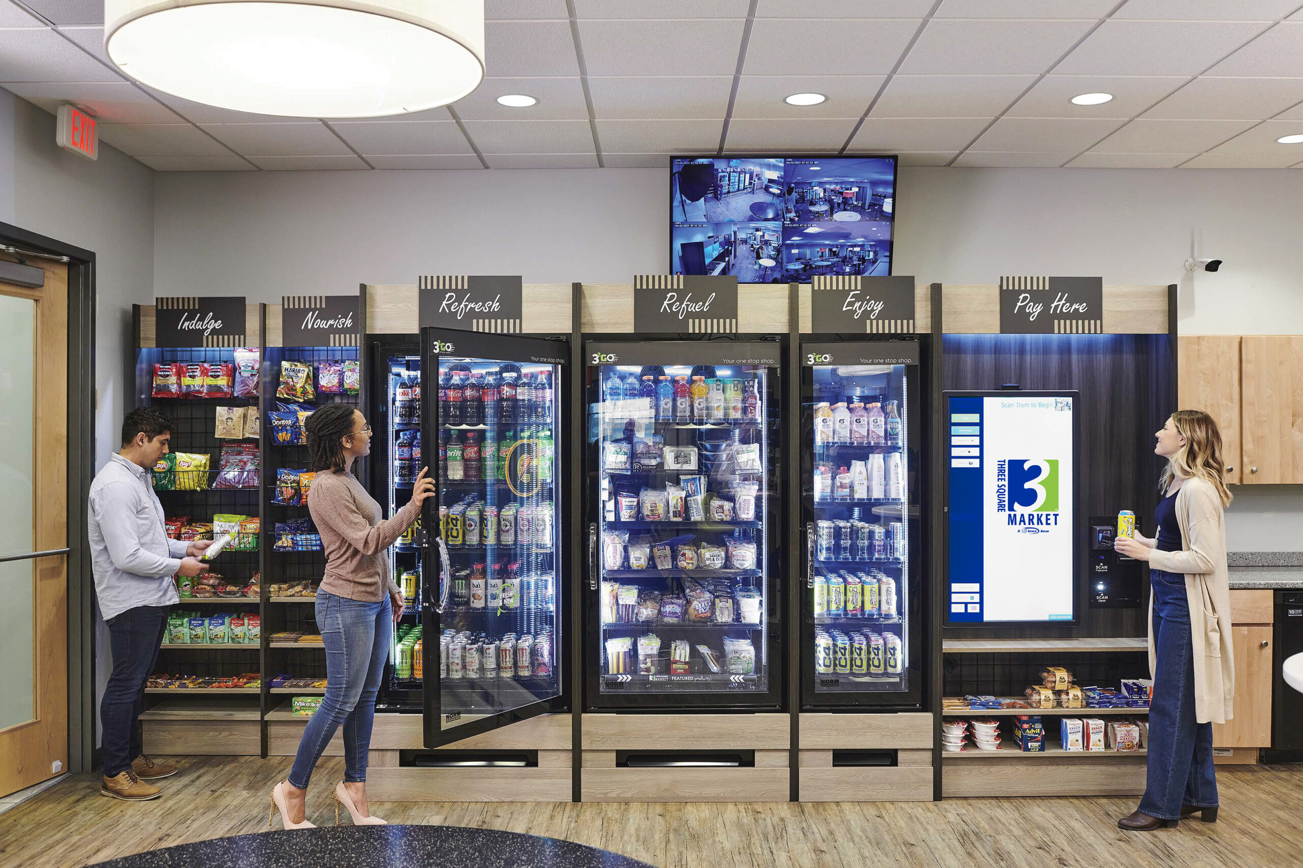 a couple of people standing in front of a vending machine